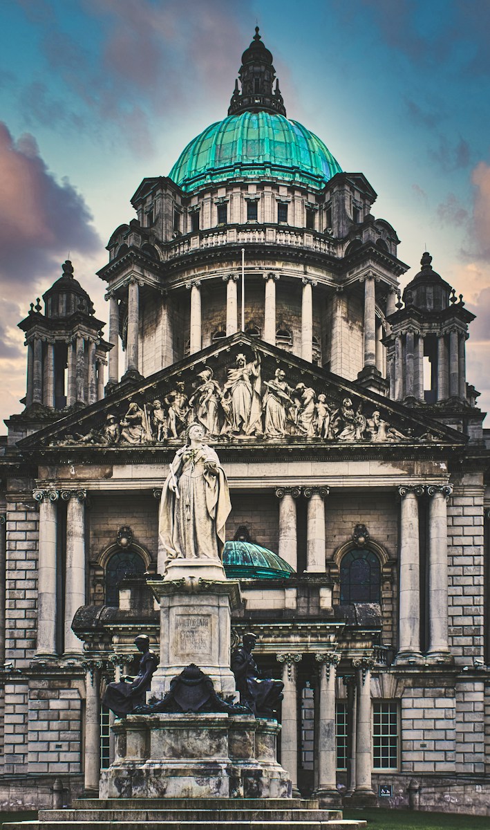 statue of man in front of building